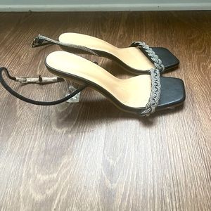 Women’s Black and silver stiletto with clear heels.